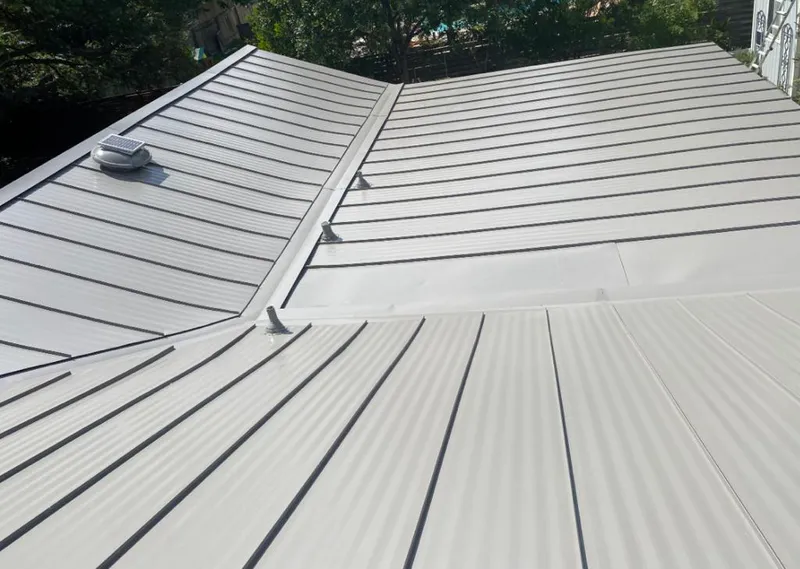 Solar attic fan installed on a metal roof for Roof Ventilation in Alamo